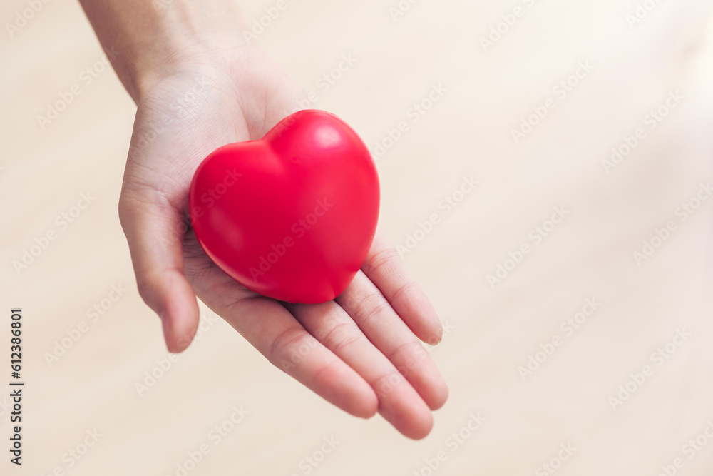 Red heart love sign in doctor hand exercise ball with copy space for World heart health dayday, World hypertension heart attack day. Red heart love sign in doctor hand exercise ball with copy space for World heart health dayday, World hypertension heart attack day.