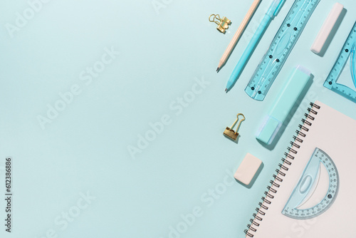 School supplies on blue background. Back to school concept. Top view. Copy space.
