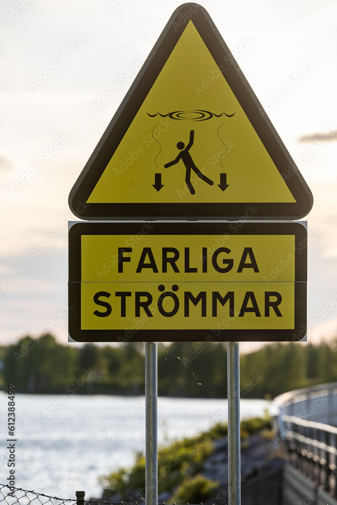 Skelleftea, Sweden A sign at a dam says in Swedis: Dangerous currents