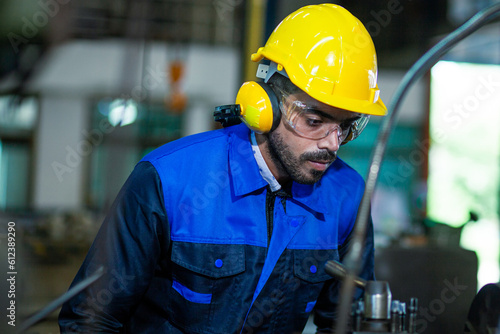 male worker checking Maintenance of industrial machines. The concept of heavy industry.male worker checking Maintenance of industrial machines. The concept of heavy industry. © KANGWANS