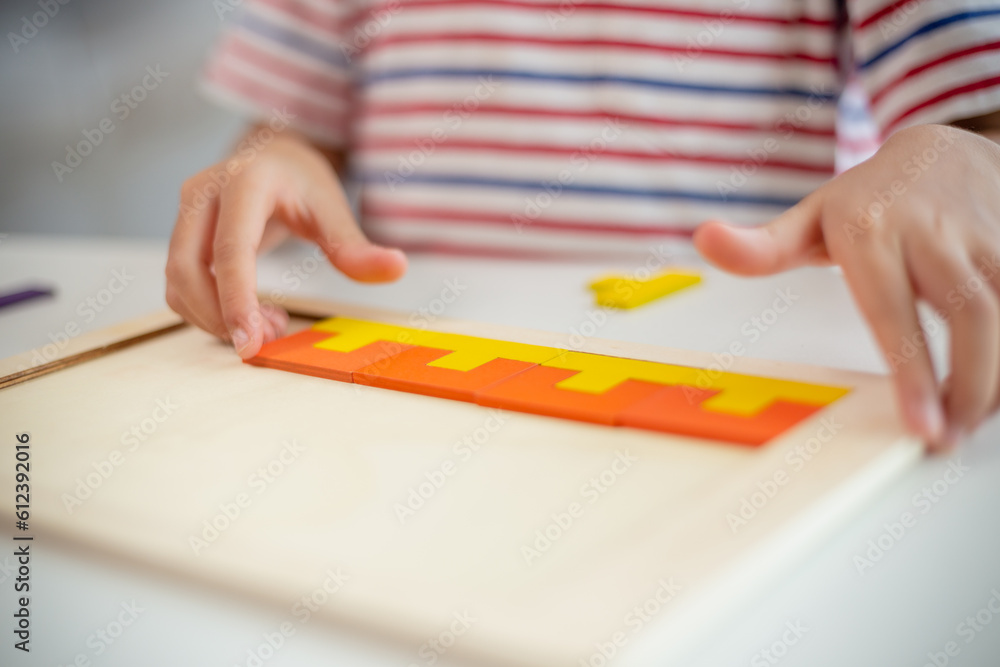 Asian girls play with puzzles, learn math, education concept Asian girls play with puzzles, learn math, education concept