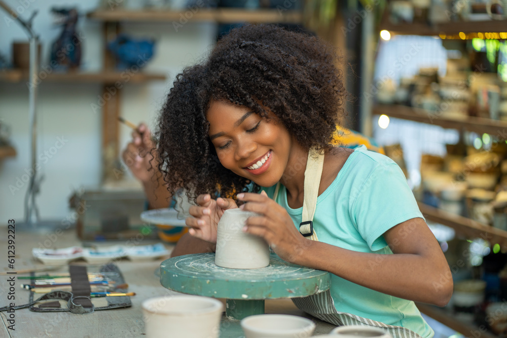 Young woman create clay and ceramic art dishes in pottery workshop Young woman create clay and ceramic art dishes in pottery workshop