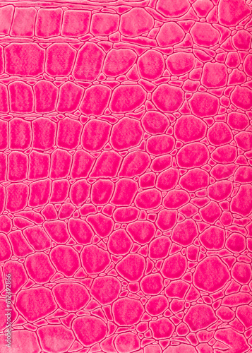 Abstract texture of imitation crocodile skin top view. Pink vertical texture background. Reptile shiny textile, fabric design. Pink patent bright crocodile leather, background texture.