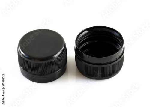 Two new black plastic caps on a white background. High dense plastic caps for plastic bottles. Circle screw lid for drink containers. Waste recycling concept.