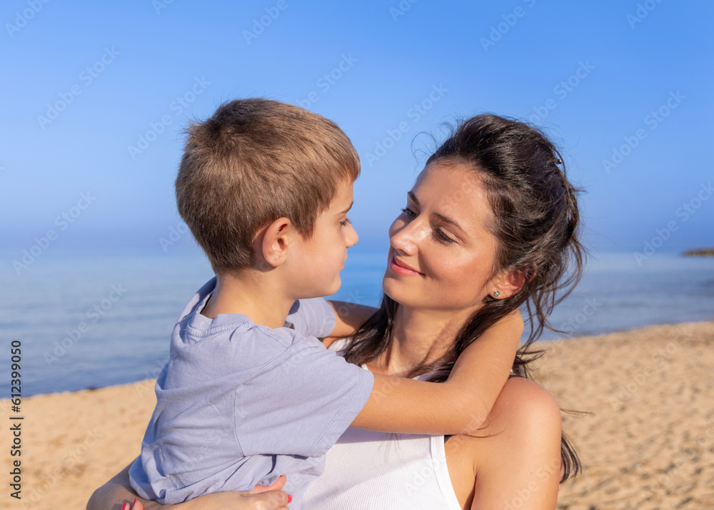 Smiling Mother and son spending time together outdoor at sunset. Lovely Family