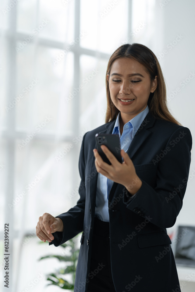 Confident Asian businesswoman smiling happy expression While using a laptop at work to start a successful small business and thrive financially. Confident Asian businesswoman smiling happy expression While using a laptop at work to start a successful small business and thrive financially.