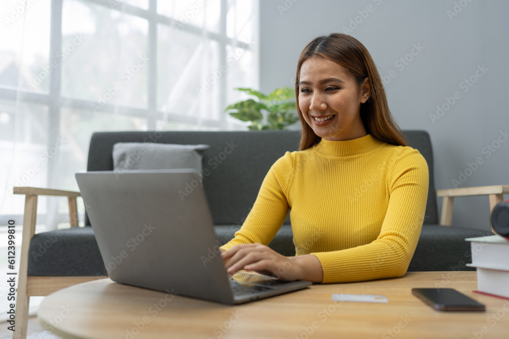 Business woman, young woman holding credit card and using laptop computer for online shopping, e-commerce, banking, internet application, spending money, working from home startup business ideas Business woman, young woman holding credit card and using laptop computer for online shopping, e-commerce, banking, internet application, spending money, working from home startup business ideas
