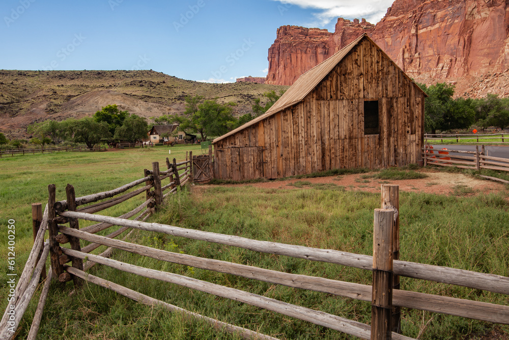 House on the prairie, with a rock face in the background. Located in ...