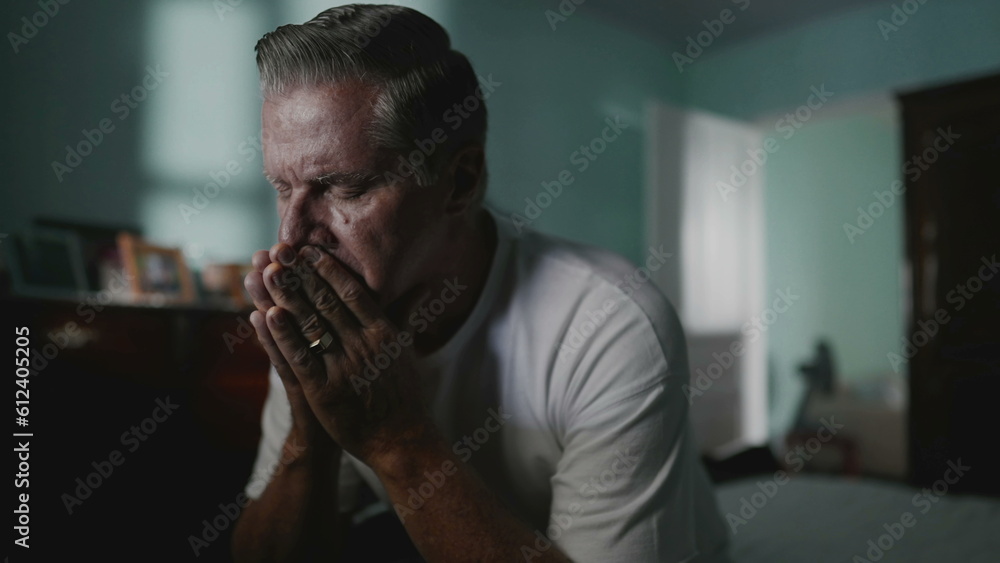 Desperate senior man covering face suffering from despair and lonliness. Older middle-aged person covering face in shame, struggling with anxiety and mental illness Desperate senior man covering face suffering from despair and lonliness. Older middle-aged person covering face in shame, struggling with anxiety and mental illness