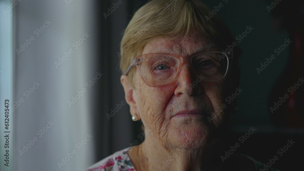 Close-Up of Elderly Woman with Serious Expression Looking at Camera, Dramatic Lighting Accentuating Experience and Old Age Close-Up of Elderly Woman with Serious Expression Looking at Camera, Dramatic Lighting Accentuating Experience and Old Age