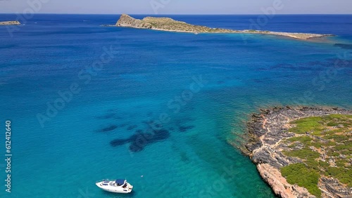 Orbiting drone of boats floating on a crystal clear ocean in Greece (Kolokitha, Crete) photo