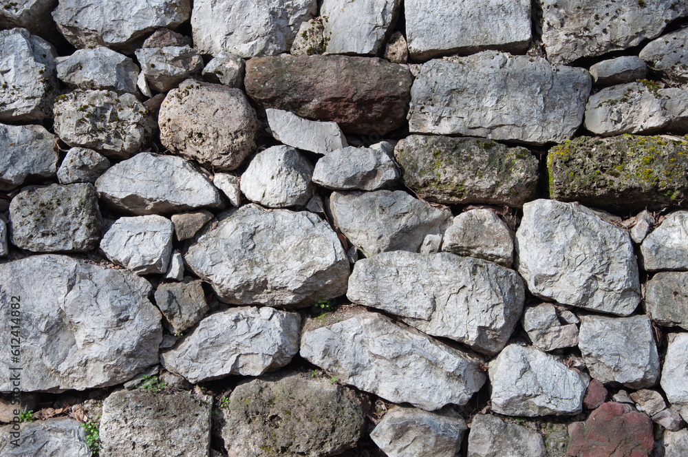 Old grey rough stone wall background Old grey rough stone wall background