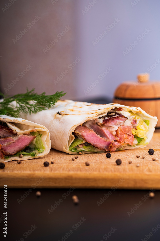 Delicious kebab with meat, lettuce, tomato, onion and sauce with french fries. Delicious kebab with meat, lettuce, tomato, onion and sauce with french fries.