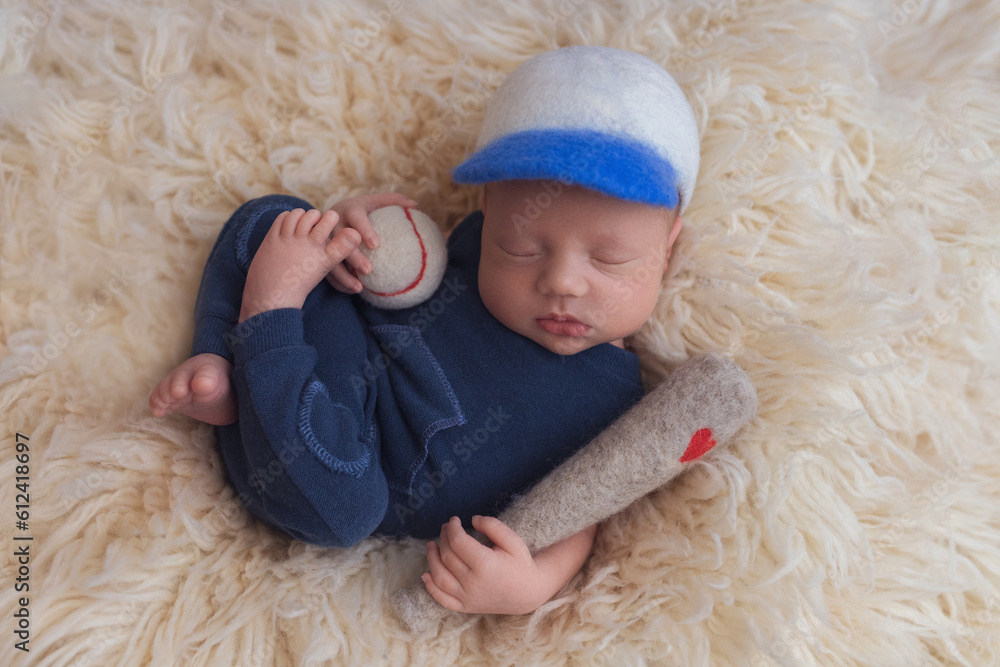 Newborn baby in a blue bodysuit. The first shooting of the baby. Newborn baby in a blue bodysuit. The first shooting of the baby.