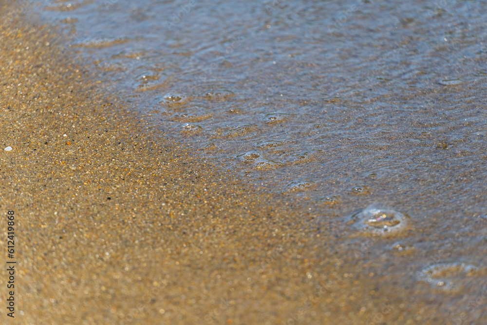 Sand and sea water on the beach in Angra do Reis, in Rio de Janeiro. Sunny day in the morning. Close-up Sand and sea water on the beach in Angra do Reis, in Rio de Janeiro. Sunny day in the morning. Close-up