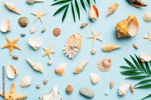 Summer time concept Flat lay composition with beautiful starfish and sea shells on colored table, top view