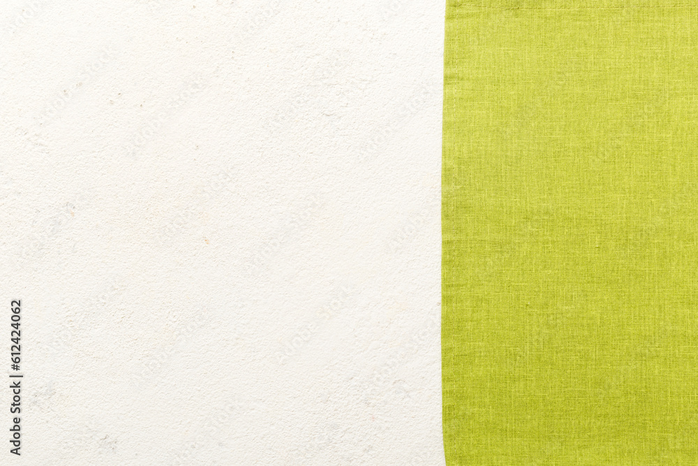 top view with green kitchen napkin isolated on table background. Folded cloth for mockup with copy space, Flat lay. Minimal style top view with green kitchen napkin isolated on table background. Folded cloth for mockup with copy space, Flat lay. Minimal style