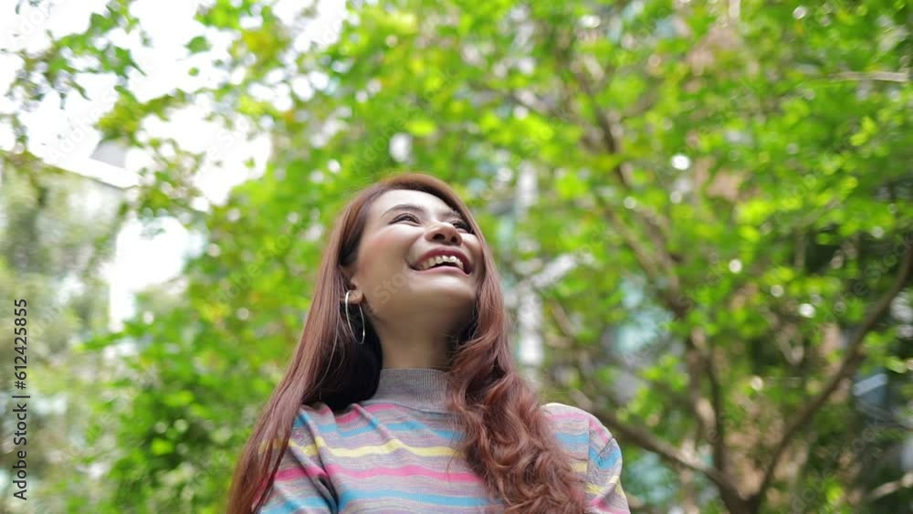 Happy smiling Asian woman Stand and breathe fresh air in the outdoor garden of a modern apartment. Housing concept. Women live in the city. Starting to live happily Happy smiling Asian woman Stand and breathe fresh air in the outdoor garden of a modern apartment. Housing concept. Women live in the city. Starting to live happily
