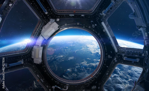 Blue Earth in ISS station porthole. View from Cupola. International space station. Orbit of planet. Elements of this image furnished by NASA