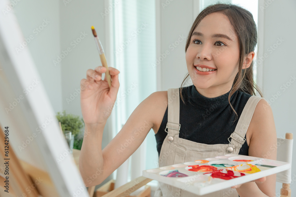 beautiful female hobbies about artist and use paintbrush in abstract