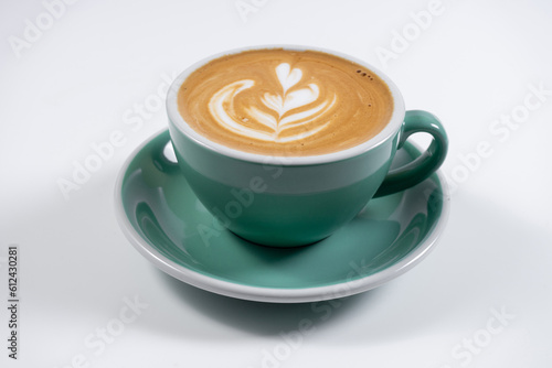 closeup of hot coffee latte with milk foam in ceramic cup on white background