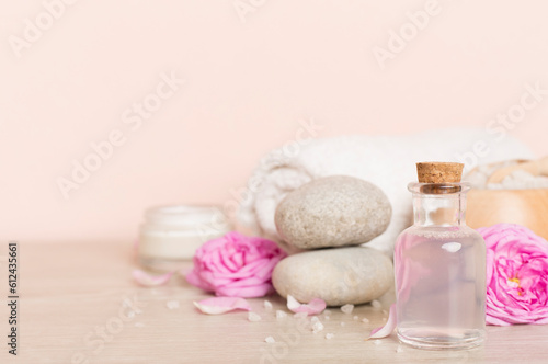 Spa composition with pink roses on wooden table
