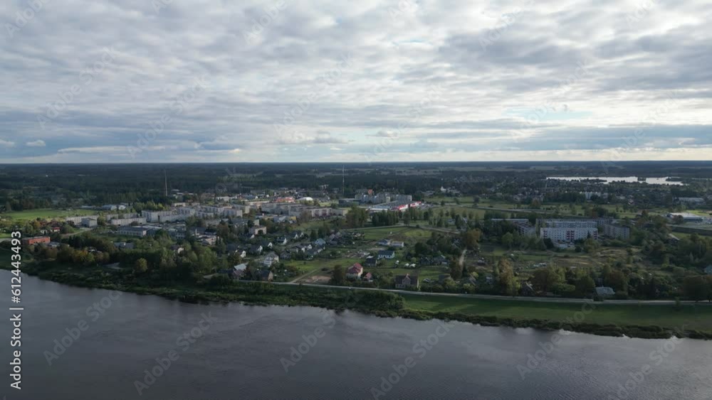 Bird's eye view of River Daugava flowing through Jekabpils, Latvia under a cloudy sky Bird's eye view of River Daugava flowing through Jekabpils, Latvia under a cloudy sky