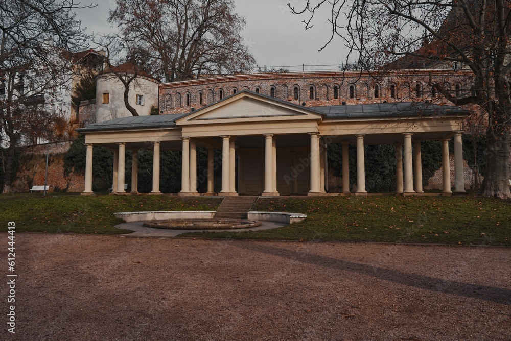 an image of an old building with columns in the park