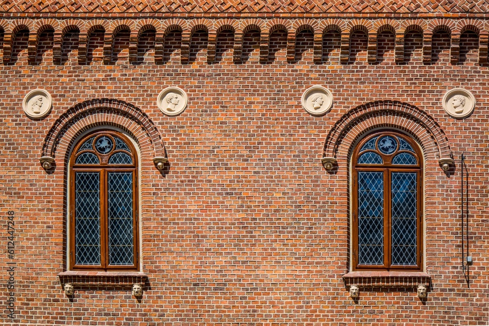 Close-up shot of cross hatch styled windows on a brick building in Krakow, Poland