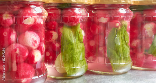Obraz na plátně Close up photo of organic pickled radish in glass jars, selective focus in the center of the frame