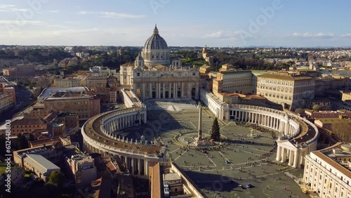 Aerial footage of Vatican Square and surrounding buildings under blue sky