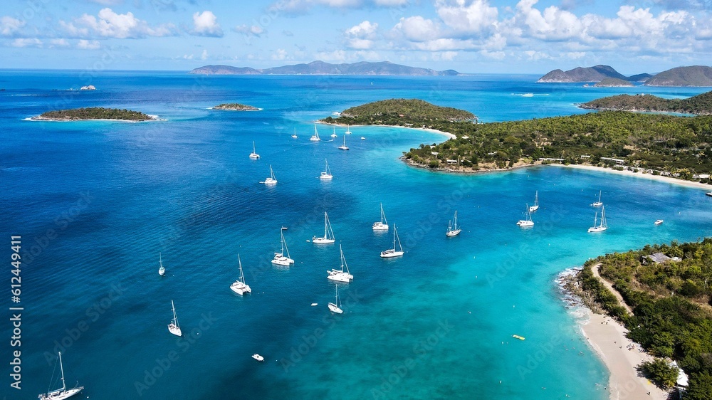 Aerial shot over a blue beach with boats