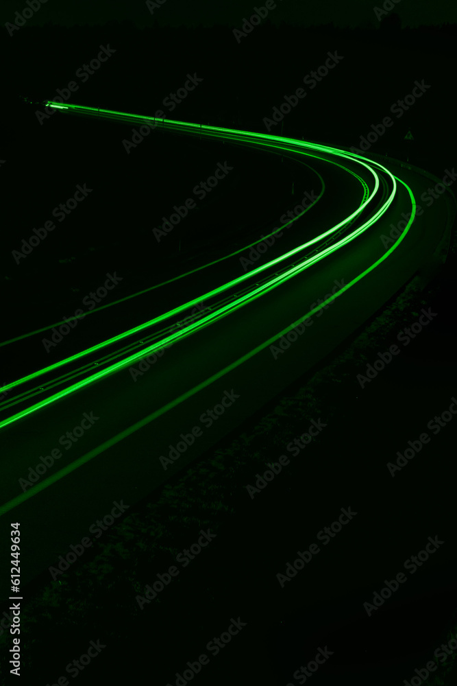 green car lights at night. long exposure green car lights at night. long exposure