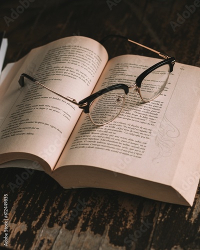 Closeup of glasses on open book