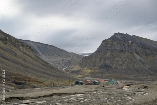 Beautiful shot of a landscape with mountains and buildings under the clouds in Svalbard, Norway