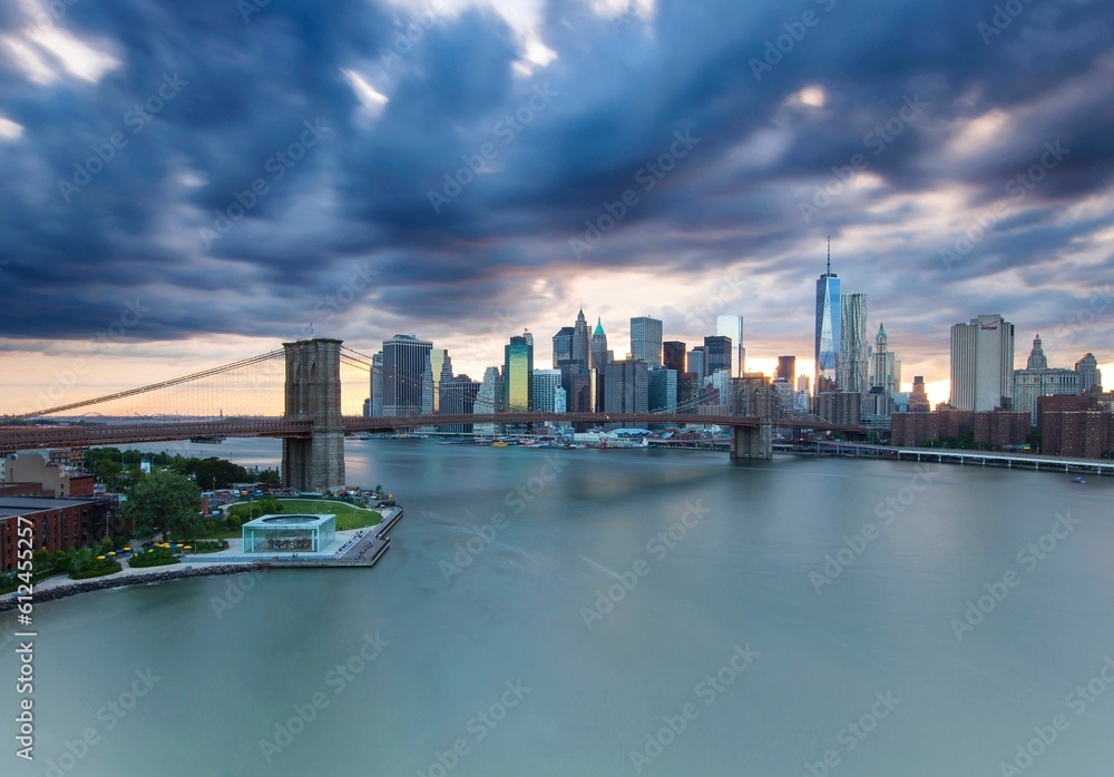 Beautiful cloudy sky over the Brooklyn bridge with a city view behind