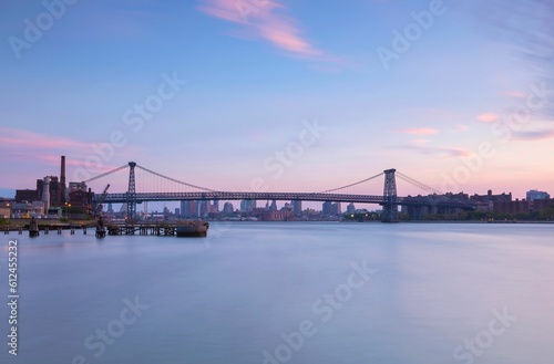Scenic shot of the city of New York and Brooklyn bridge during the evening with a pink and blue sky