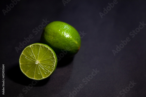 Obraz na płótnie Limes against dark background, top view with copy space w salonie