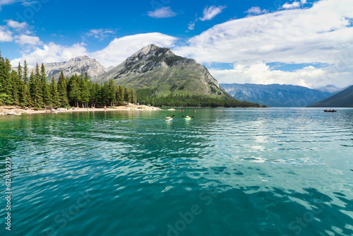 Vacationers enjoy a kayak on Lake Minnewanka with Mt. Astley in the background near Banff in the Canada Rockies