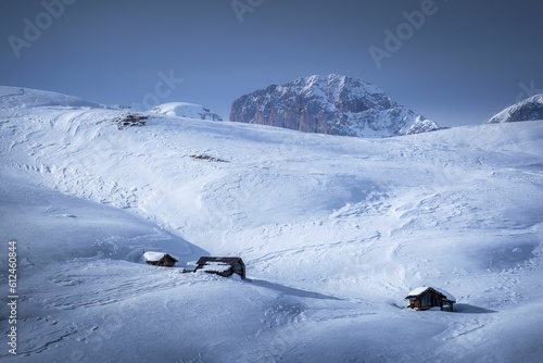 Landscape of a snowy hillside with wooden rural houses