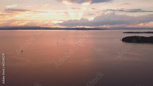 Aerial view of a sunset over waves and sailing boats on lake Champlain, Vermont shot in slow motion photo
