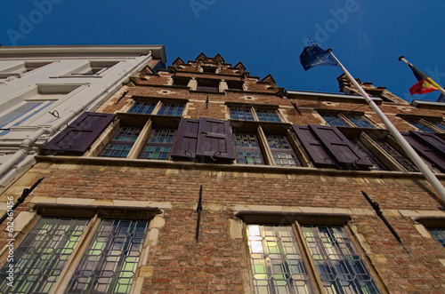 Scenic wide-angle view of the ancient brick wall of Rubens House against blue sky. Famous touristic place and travel destination in Europe. UNESCO World Heritage Site. Antwerp, Belgium photo