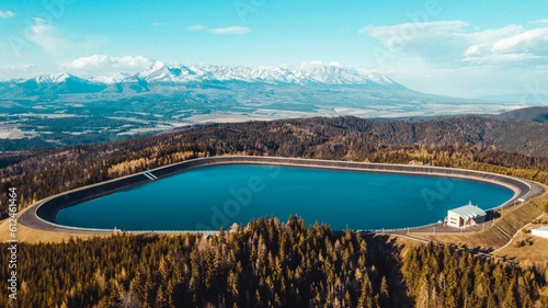 Aerial shot of Pumped Storage Power Plant Cierny Vah, High Tatras mountains in the background
