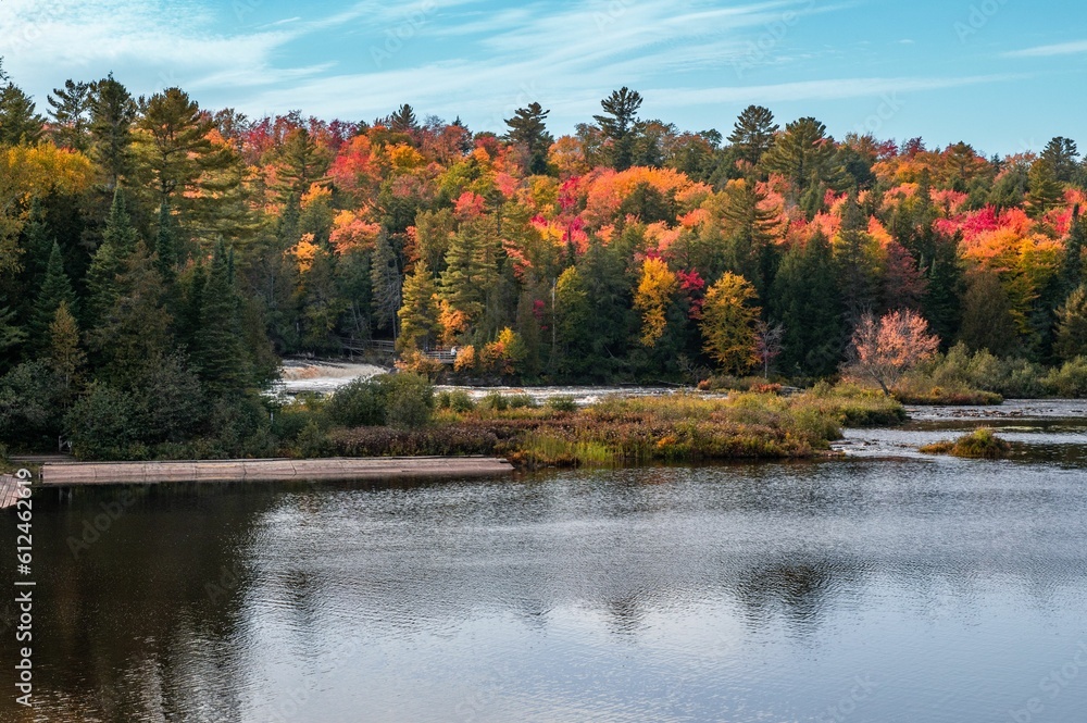 Scenic lower falls of Tahquamenon Falls state park in Michigan surrounded by autumn foliage