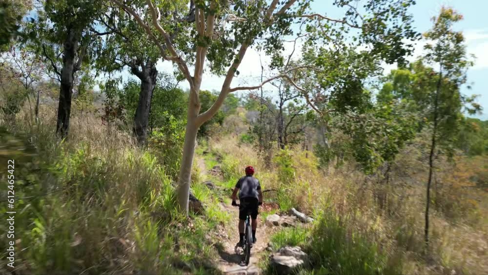 High angle of person riding a bicycle through Pallarenda mountain trail in Townsville, Queensland High angle of person riding a bicycle through Pallarenda mountain trail in Townsville, Queensland
