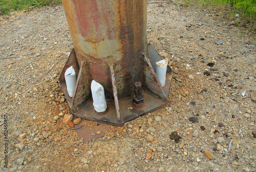 Ground anchor bracket for securing a metal post into the soil
