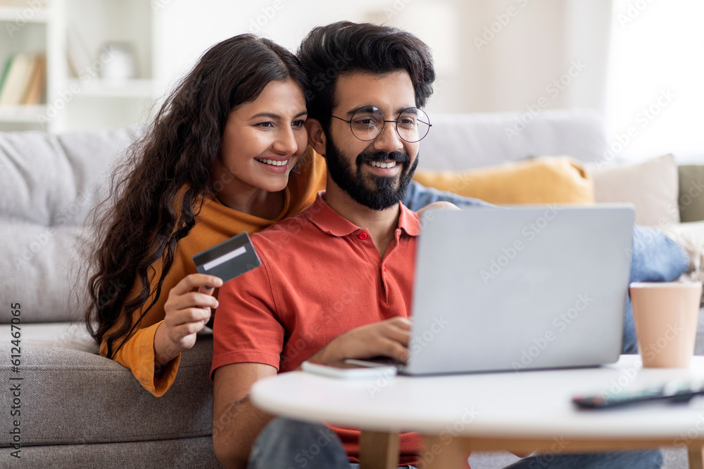Online Auction. Indian Couple With Laptop And Credit Card Making Internet Bids Online Auction. Indian Couple With Laptop And Credit Card Making Internet Bids