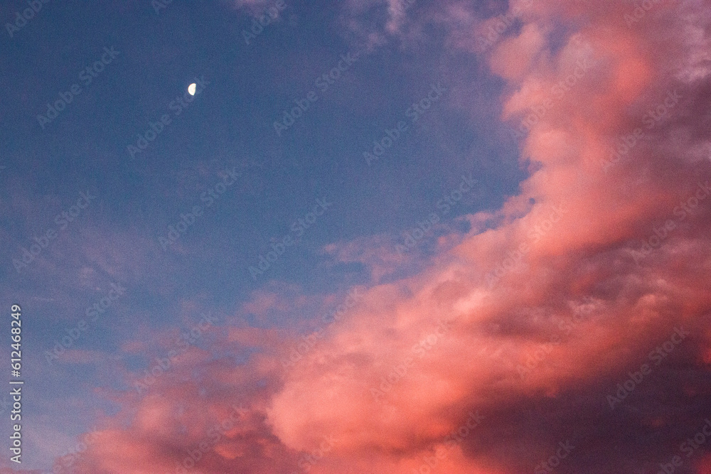 Pink clouds with the moon in the sky
