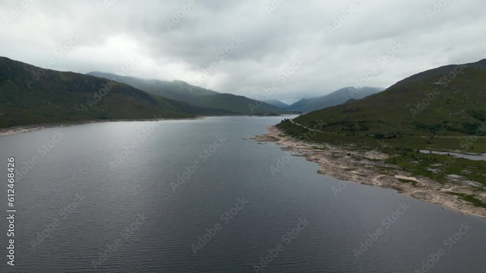 Aerial view of the green cliffs near a lake in Fort William, Isle of Skye, Scotland Aerial view of the green cliffs near a lake in Fort William, Isle of Skye, Scotland