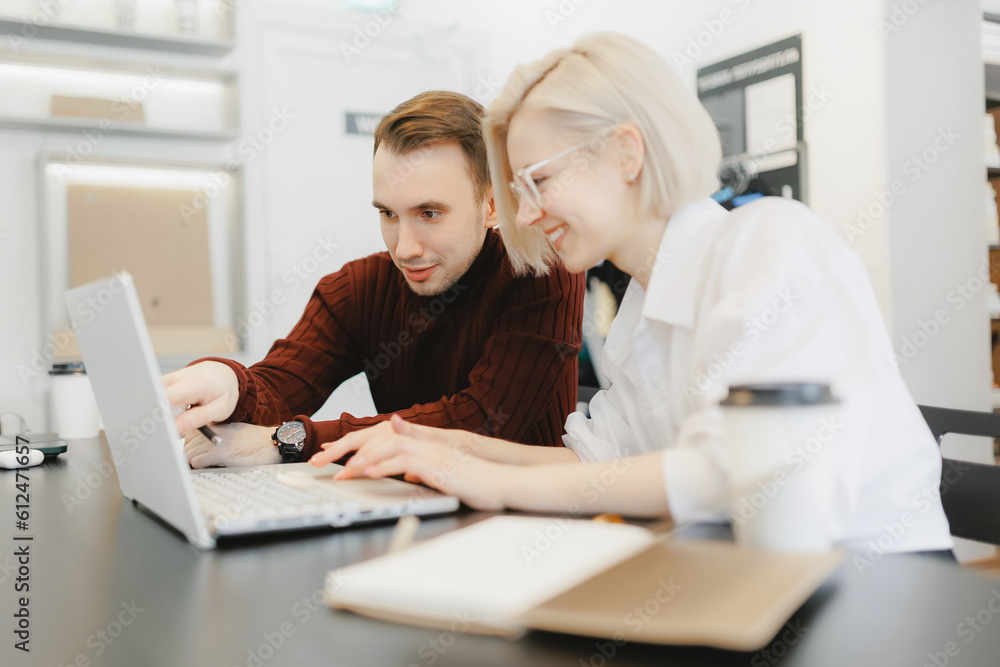 University students friends learning information for IT project or exam. Young people doing group study at table with laptop
